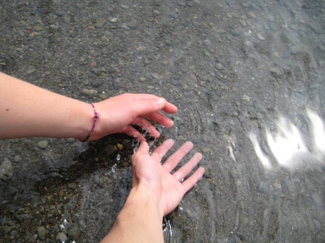 Hands touching in shallow water 640x480